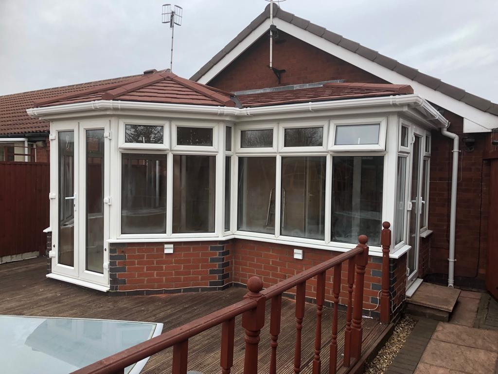 Conservatory with a newly completed tiled roof