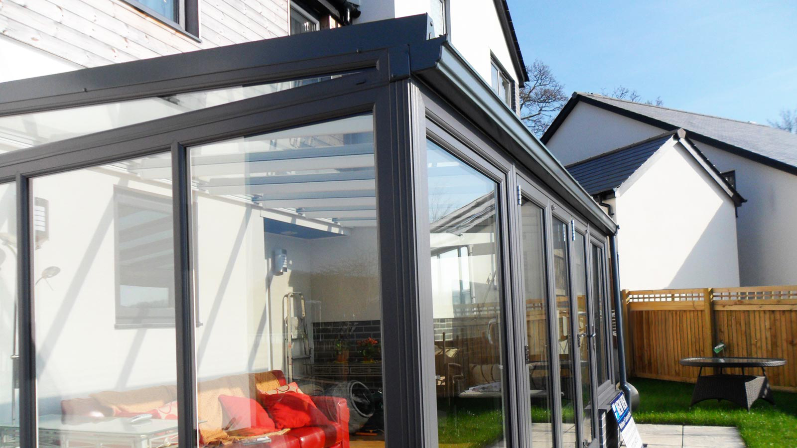 A Lean To Conservatory with black frames installed by KLG Rutland