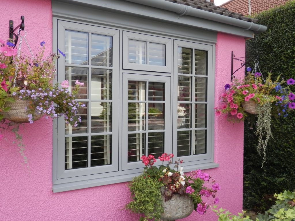 flush sash windows set in a pink house wall