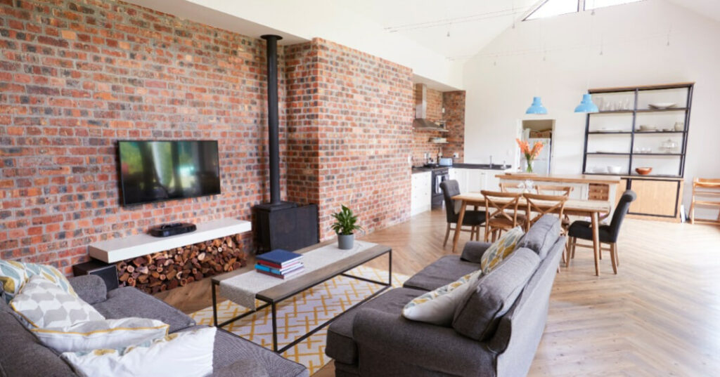 conservatory with brick wall and log burner