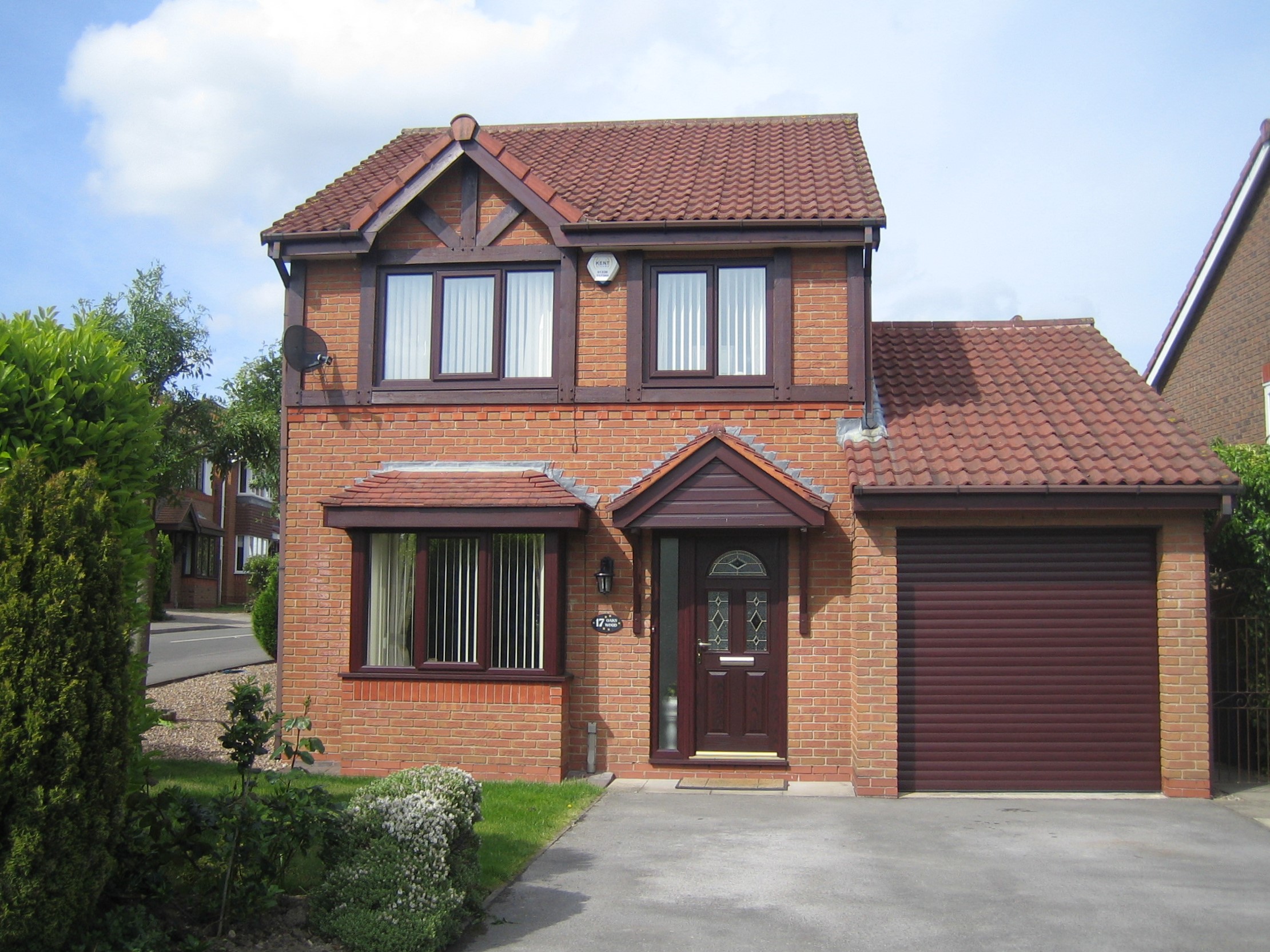 Brown bay windows shown on a house, wide shot