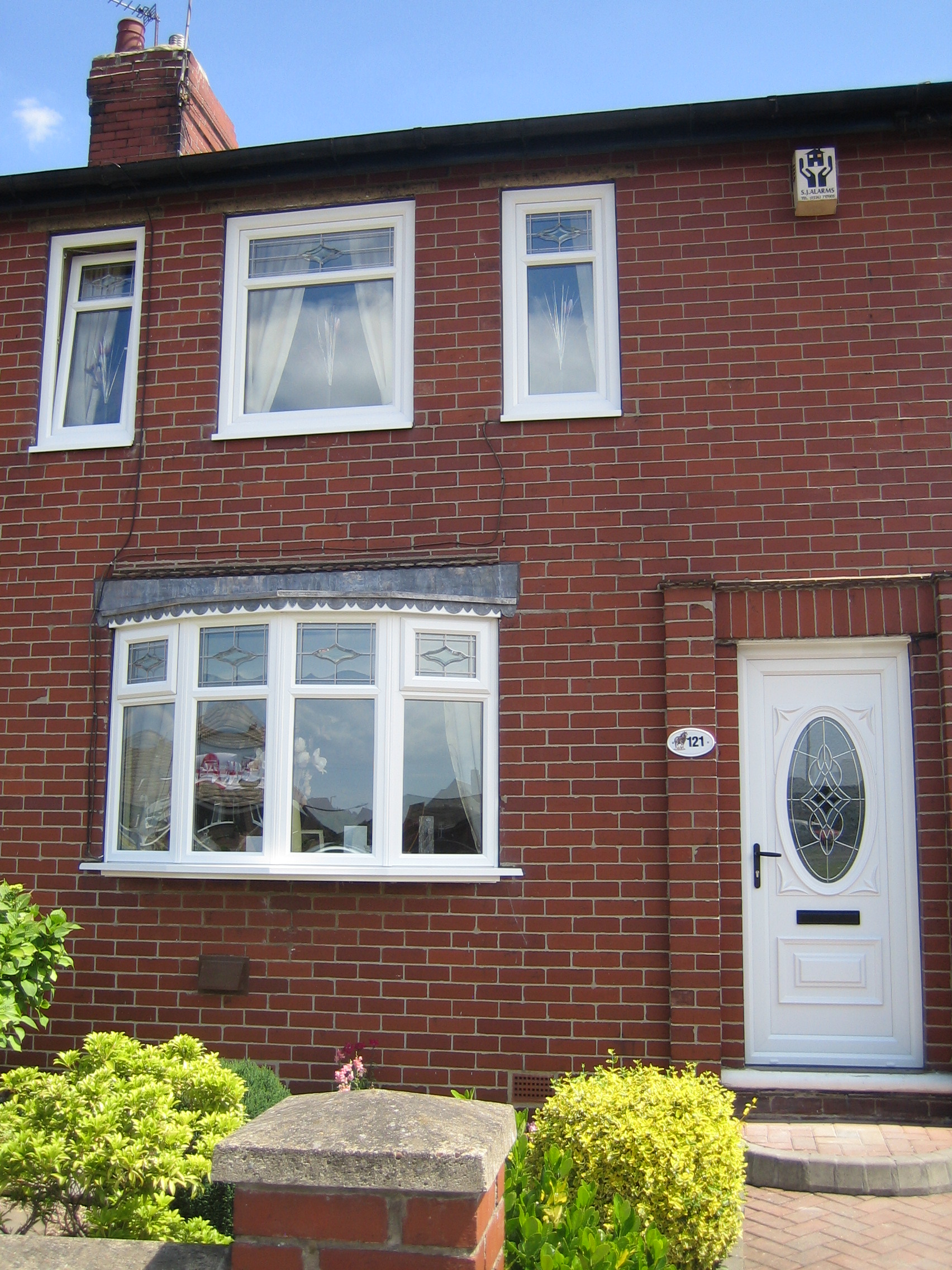 Wide shot of white bay windows installed