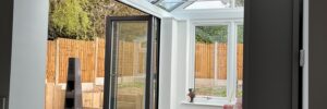 An interior view of bi fold doors in a conservatory